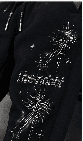Macro detail of hand-set rhinestone starburst on black fleece